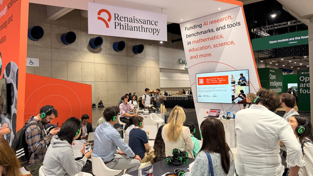 Renaissance Philanthropy booth hosting attendees during a research presentation at a conference