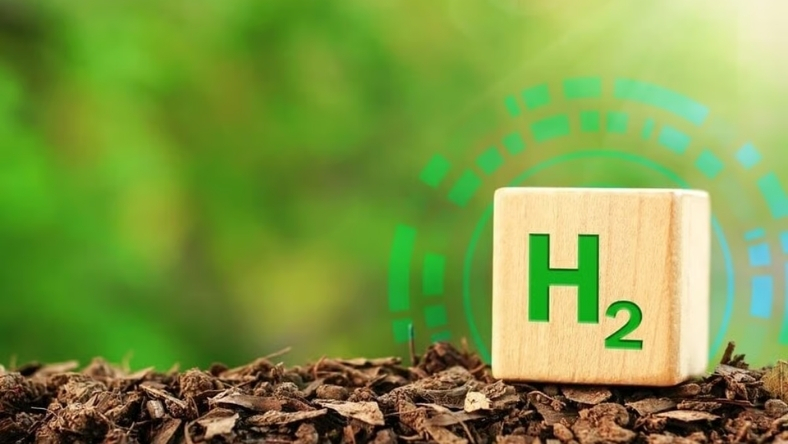 Cube with H2 symbol resting on soil representing hydrogen energy concept