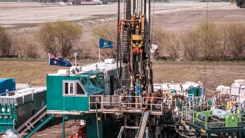Onshore drilling rig operating in rural landscape