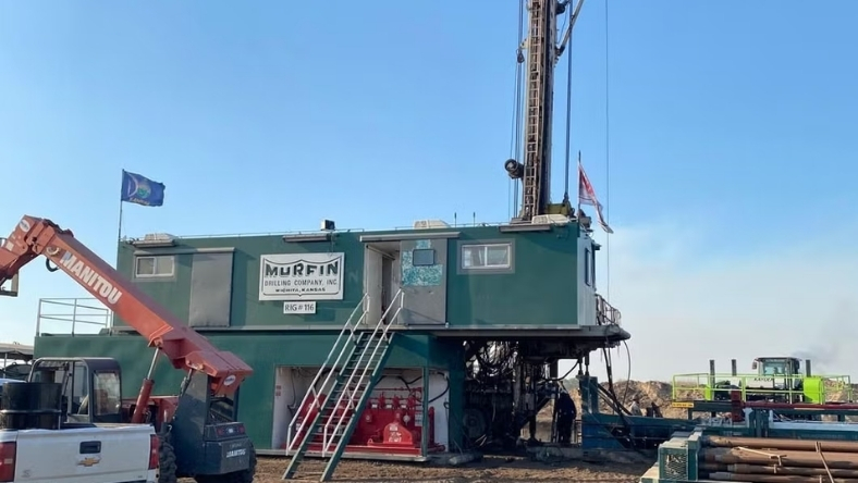 Kansas wellsite with active drilling rig and site office